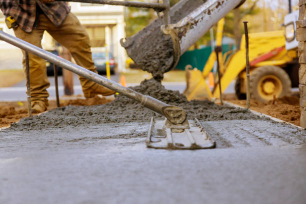 Worker working for concrete pavement for ground construction stock photo