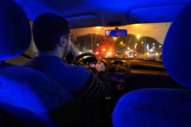 istock Man driving at night through the city 1215011297