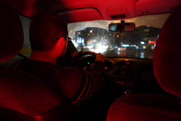 istock Man driving at night through the city 1215011319