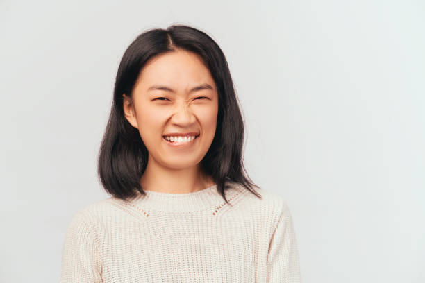 istock Portrait of girl making faces laughing biting lips 1215011581