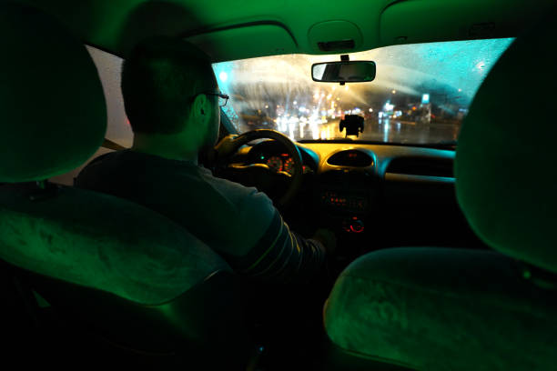 istock Man driving at night through the city 1215011651