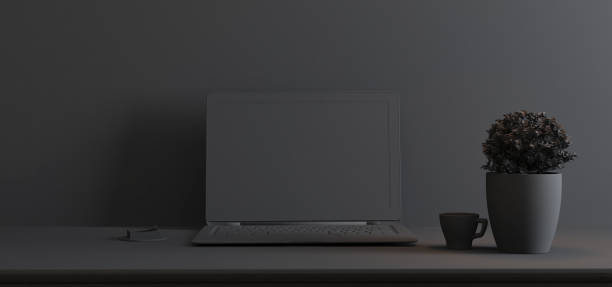 istock Work space stand mock up with table and plant, laptop, cup front wall single color 3D rendering 1215012882