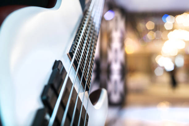 istock A white electric bass guitar with five strings close-up. Blurred background. 1215013113