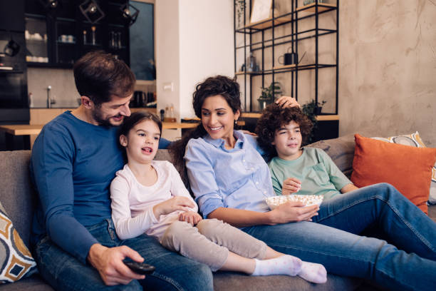 istock Family spending time at home with TV and popcorn 1215013187