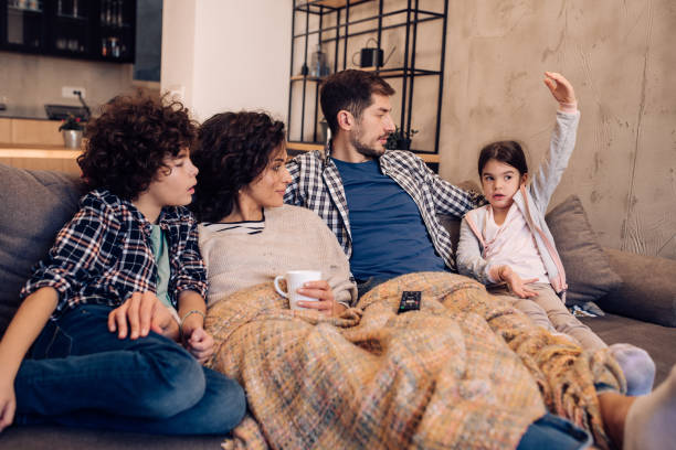 istock Family relaxing on the couch 1215013221