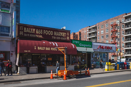 Flushing, New York City - April 24, 2019: Shops on Roosevelt Ave in Flushing Chinatown