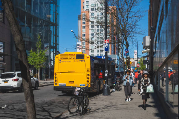 Flushing, New York City - April 24, 2019: Pedestrian walking down street in downtown Flushing Chinatown