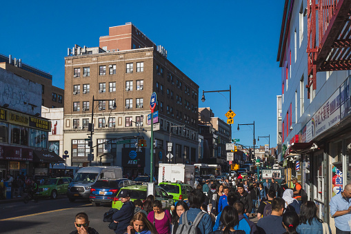 Flushing, New York City - April 24, 2019: Pedestrian and traffic in downtown Flushing Chinatown