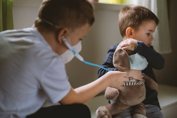 istock Kids pretending to be doctors while playing at home 1215016881