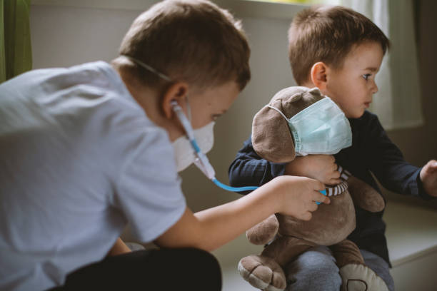 istock Kids pretending to be doctors while playing at home 1215017213