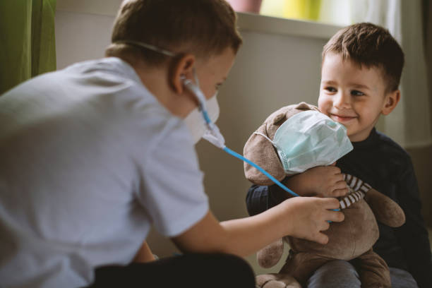 istock Kids pretending to be doctors while playing at home 1215017271