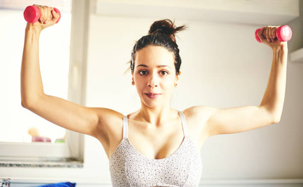 istock Attractive fit woman doing workout at home. 1215018295