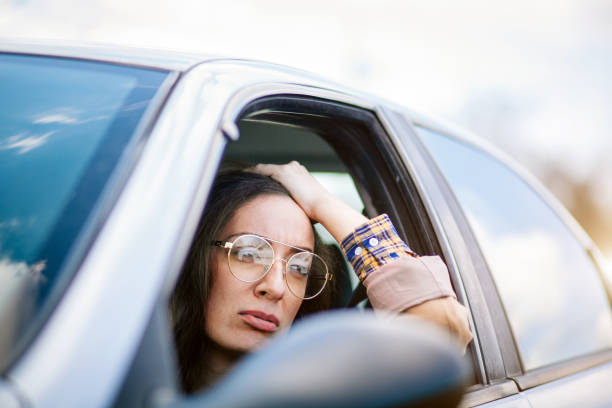 istock Young woman driving car 1215018301