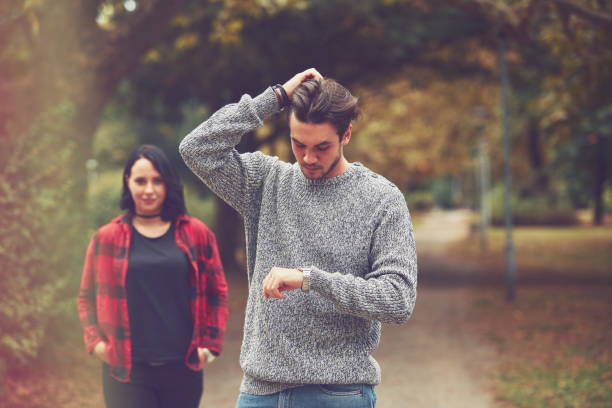 istock Young man waiting for his lady and checking time. Love concept. 1215019599