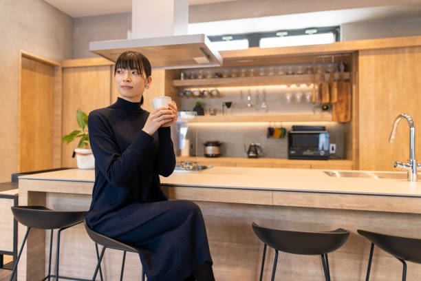 istock Young woman holding coffee cup in cafe 1215021126