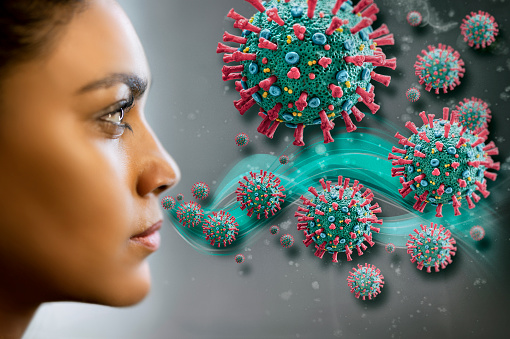 Woman inhaling corona virus COVID-19.\nThe image is a scientific interpretation of the virus with all relevant details : Spike Glycoproteins, Hemagglutinin-esterase, E- and M-Proteins and Envelope.