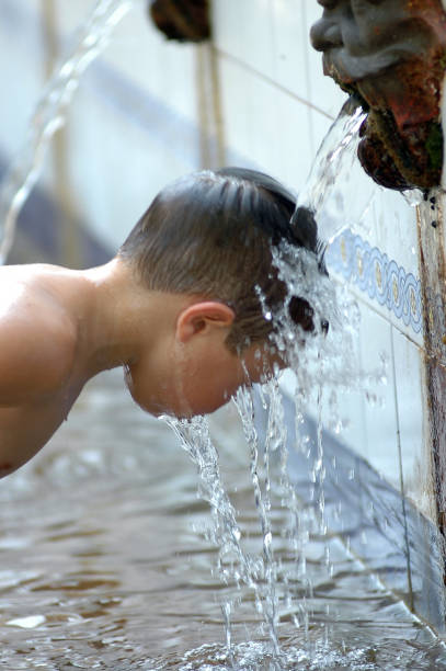istock Young Boy at water spouts in Valencia Spain 1215023267