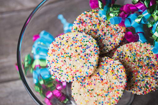 Enjoying sprinkle cookies for a party