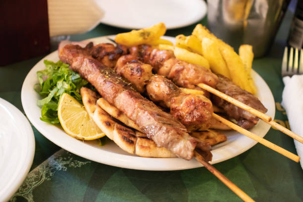 traditional souvlaki greek dish with chicken and meat in athens - opa! souvlaki of greece imagens e fotografias de stock