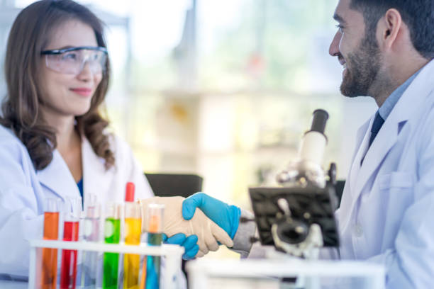 istock Male and female scientists touch hands when a successful experiment in the laboratory. 1215024838