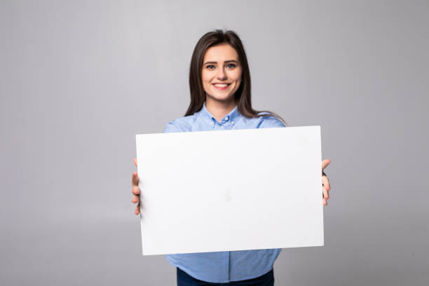 istock Woman holding blank card isolated on white background 1215025032