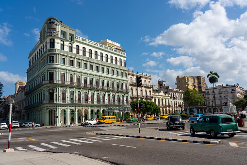 Old Havana hotel with classic colonial architecture on a common day of traffic and tourist steps through the city. Havana .Cuba. 10 January 2020