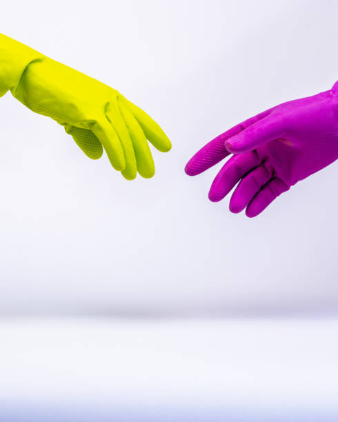 istock Two People Wearing Protective Gloves Reach Out To Touch 1215032600