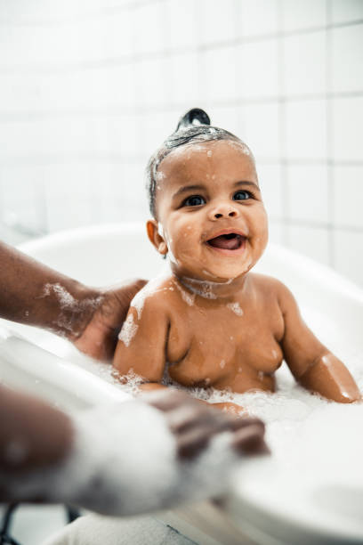 istock Cute Afro American baby taking bath and smiling 1215033464