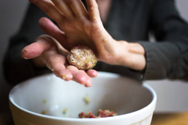 istock Woman Rolling Meatballs Close-Up 1215034318