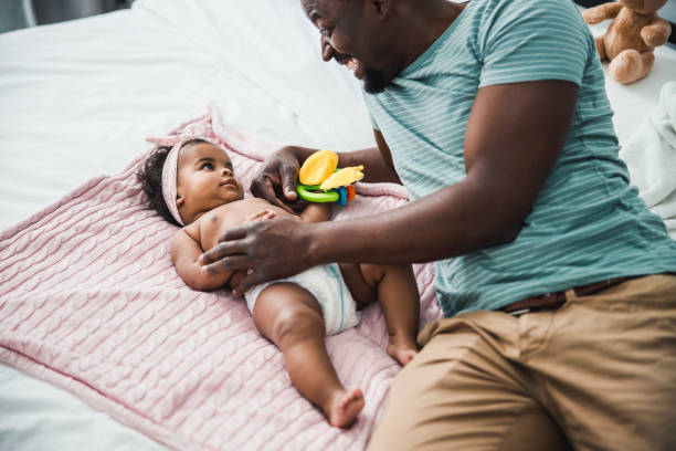 istock Happy Afro American father playing with newborn daughter 1215034329