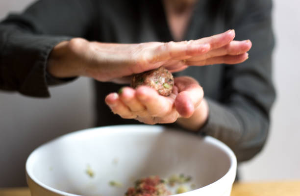istock Woman Rolling Meatballs Close-Up 1215034337