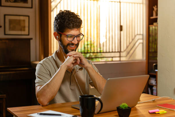 Gorgeous latin laughing during video conference. Home office concept