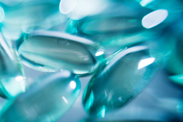 istock Transparent gel capsules on dark black background 1215041204