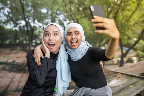 istock Young young hijab women resting and selfie ar park 1215045284