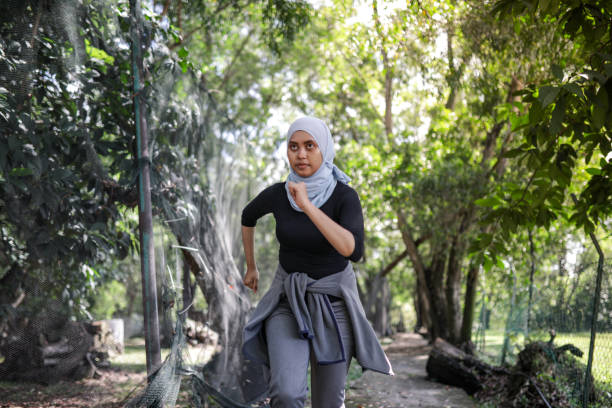 istock Young beautiful hijab women jogging at park 1215045322