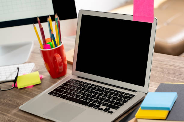 istock laptop computer on wooden desk Laptop with blank screen on table Laptop with blank screen on table interior 1215048068