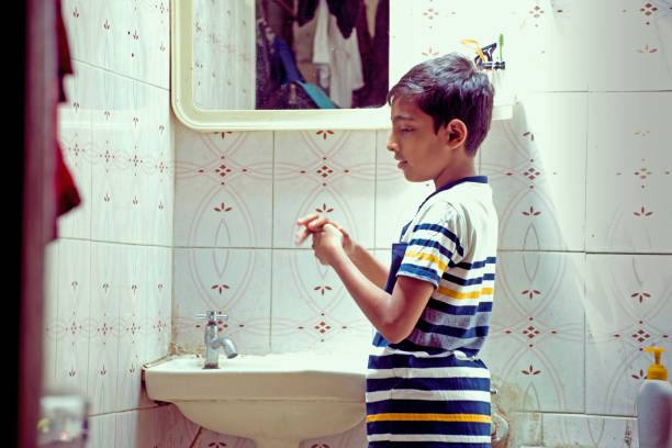 istock boy washing hand at home 1215050938