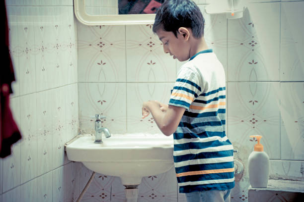 istock boy washing hand at home 1215050982