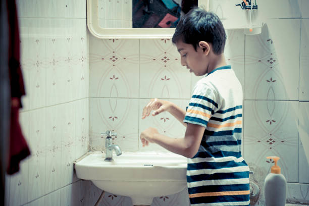istock boy washing hand at home 1215050984