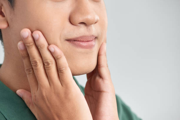 istock Men Face Care. Man Touching Smooth Skin After Shaving 1215055459