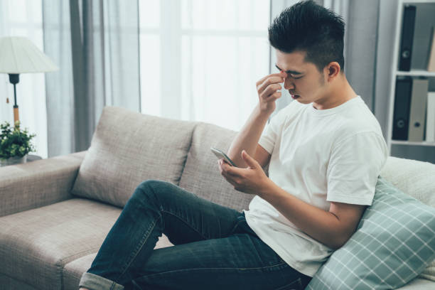 istock depressed guy sitting on couch in home 1215055697