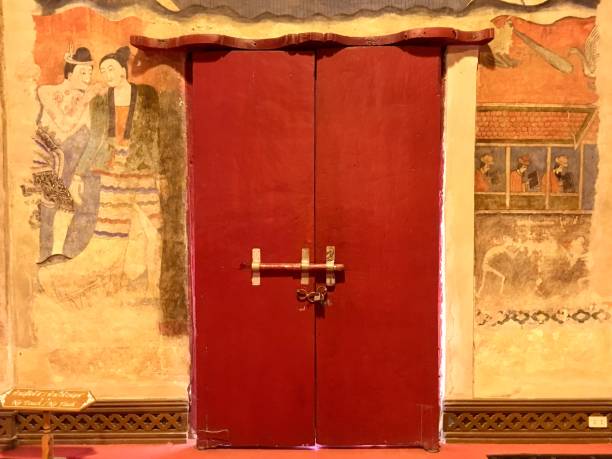 istock Ancient mural wall painting and red door at Phumin temple 1215058204