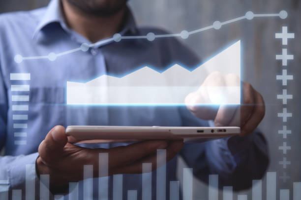 istock Man holding tablet with a business graph. Growth. Business. Success 1215059737