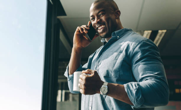 istock Smiling businessman talking on phone 1215066545