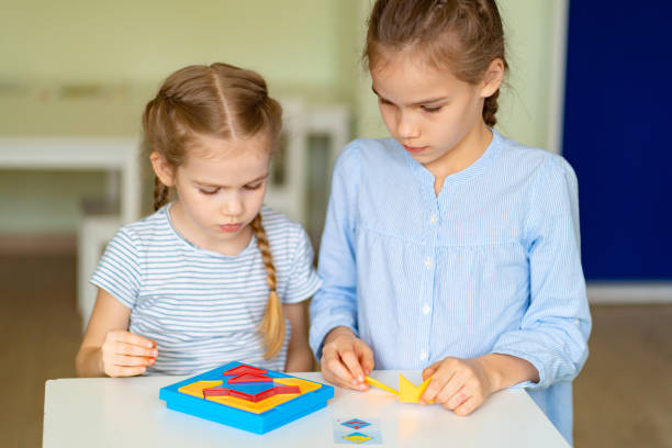istock two little girl solve mathematical puzzle 1215068434