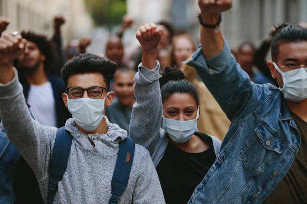 istock Group of demonstrators protesting in the city 1215069129