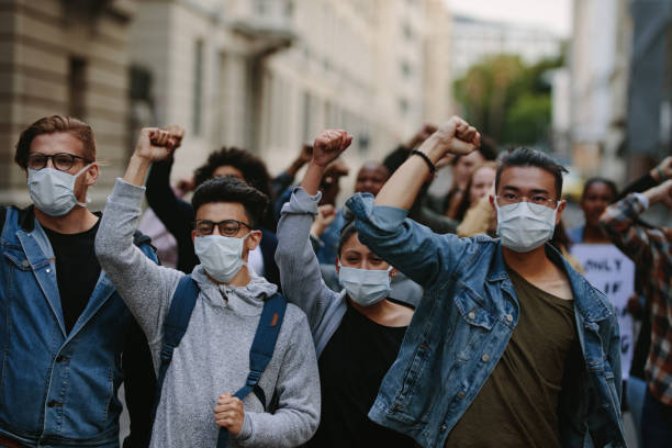 istock People marching together in a protest 1215069216