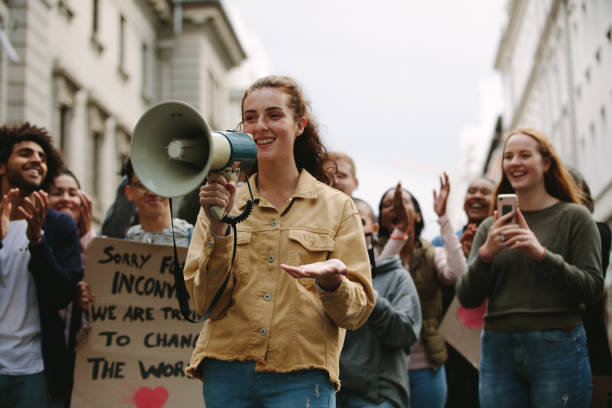 istock Woman with a megaphone in a rally 1215069365