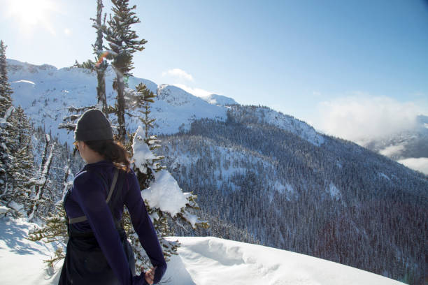 istock Female back country ski mountaineer stretches while admiring view 1215070148