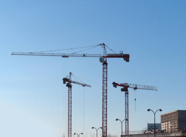 istock Abstract Industrial background with construction cranes silhouet 1215072360